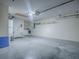 Spacious garage featuring laundry area, water heater, and plenty of storage space at 2799 Privada Dr, The Villages, FL 32162