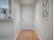 Bright hallway features wood flooring and neutral walls with modern decor, leading to other parts of the home at 2799 Privada Dr, The Villages, FL 32162