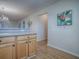 Bright kitchen connects to the living room with counter seating and wooden cabinets at 2799 Privada Dr, The Villages, FL 32162