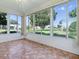 Lanai featuring tile flooring and large windows showcasing the well-maintained front yard at 2799 Privada Dr, The Villages, FL 32162