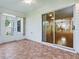 An enclosed lanai features tile flooring with a sliding glass door and ceiling fan at 2799 Privada Dr, The Villages, FL 32162