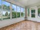 Enclosed lanai featuring tile flooring and views of the backyard and surrounding neighborhood at 2799 Privada Dr, The Villages, FL 32162