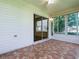 An enclosed lanai features tile flooring with a sliding glass door and ceiling fan at 2799 Privada Dr, The Villages, FL 32162