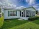 A charming home exterior features a cozy sunroom perfect for enjoying the outdoors at 2799 Privada Dr, The Villages, FL 32162