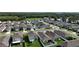 From above, a residential area boasts manicured lawns, white fences, and a tranquil, verdant backdrop at 29810 Anahid Dr, Leesburg, FL 34748