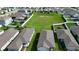 This aerial view showcases a neighborhood with well-maintained lawns and white-fenced yards at 29810 Anahid Dr, Leesburg, FL 34748