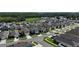 An aerial view of a neighborhood showcasing similar two-story homes with well-manicured lawns and community landscaping at 29810 Anahid Dr, Leesburg, FL 34748