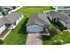 Aerial view of a one-story home showing a brick-paved driveway and well-kept landscaping at 29810 Anahid Dr, Leesburg, FL 34748