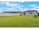 Spacious backyard featuring a lush green lawn, complemented by a white fence for added privacy at 29810 Anahid Dr, Leesburg, FL 34748
