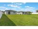 A well-maintained backyard featuring a lush green lawn, complemented by a secure white fence at 29810 Anahid Dr, Leesburg, FL 34748