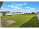 Expansive backyard perfect for outdoor activities, featuring a paver patio and a secure white fence at 29810 Anahid Dr, Leesburg, FL 34748
