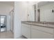 Bathroom with dual vanity, granite countertops, walk-in shower, and views of the bedroom, creating a spa-like atmosphere at 29810 Anahid Dr, Leesburg, FL 34748