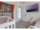 Well-organized closet and tv create a functional space in this carpeted bedroom at 29810 Anahid Dr, Leesburg, FL 34748