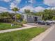 Community pool featuring a modern bathhouse, convenient parking, and a lush setting at 29810 Anahid Dr, Leesburg, FL 34748