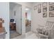 Hallway view highlighting the layout with doorways leading to other rooms and a rocking chair at 29810 Anahid Dr, Leesburg, FL 34748