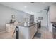 Kitchen island with sink, stainless dishwasher, and adjacent desk space and dining at 29810 Anahid Dr, Leesburg, FL 34748