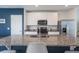 Modern kitchen with stainless steel appliances, granite countertops, and a large island, perfect for meal prep and entertaining at 29810 Anahid Dr, Leesburg, FL 34748