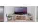 Living room displaying a TV and decorative tables with light tile flooring at 29810 Anahid Dr, Leesburg, FL 34748