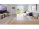 Bright living room featuring a large leather couch, tile flooring and access to the backyard at 29810 Anahid Dr, Leesburg, FL 34748