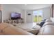 Spacious living room with a large leather couch, a backyard view, and light tile flooring at 29810 Anahid Dr, Leesburg, FL 34748