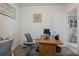 Functional office space with sleek gray chair, complemented by neutral tones, and natural light at 29810 Anahid Dr, Leesburg, FL 34748