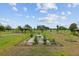Well-manicured backyard featuring an elegant gazebo, lush green space, and picturesque view at 3097 Bureau Path, The Villages, FL 32163