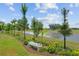 Landscaped backyard featuring a serene water view and beautiful plants at 3097 Bureau Path, The Villages, FL 32163