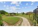 Well-manicured backyard featuring an elegant gazebo, brick paver walkway, and lush green space at 3097 Bureau Path, The Villages, FL 32163
