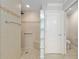 Bathroom with accessible shower and tiled walls at 3097 Bureau Path, The Villages, FL 32163
