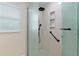 Bathroom showcasing a modern glass shower with a rainfall shower head and a convenient grab bar at 3097 Bureau Path, The Villages, FL 32163