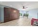 Bright bedroom with a Murphy bed, views of the lush outdoors, and light wood flooring at 3097 Bureau Path, The Villages, FL 32163