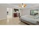 Spacious bedroom with tile floors, ensuite bath, and walk-in closet at 3097 Bureau Path, The Villages, FL 32163