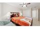 Comfortable bedroom with stylish fan, tiled floor, warm lighting and closet for ample storage at 3097 Bureau Path, The Villages, FL 32163