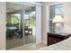 Bedroom with view of screened in patio, with dining table and chairs at 3097 Bureau Path, The Villages, FL 32163