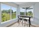 Corner breakfast nook with views of the golf course and manicured backyard at 3097 Bureau Path, The Villages, FL 32163