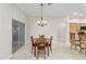 Dining area with wood table and chairs, chandelier, and sliding glass doors to the outdoors at 3097 Bureau Path, The Villages, FL 32163