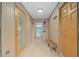Hallway leading to a bathroom with grab bars and a shower, plus other exterior access doors at 3097 Bureau Path, The Villages, FL 32163