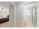 Hallway view of a bedroom and bathroom with tiled floors, offering a glimpse of comfort and convenience at 3097 Bureau Path, The Villages, FL 32163