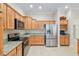 Kitchen featuring stainless steel appliances, granite countertops, and ample wood cabinetry at 3097 Bureau Path, The Villages, FL 32163