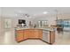 Spacious kitchen island with granite countertops, stainless steel dishwasher, and convenient bar seating at 3097 Bureau Path, The Villages, FL 32163