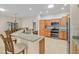 Kitchen with granite countertops, stainless steel appliances, bar seating, and a view to the dining area at 3097 Bureau Path, The Villages, FL 32163