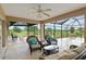 Screened lanai with wicker furniture and tranquil views of the garden and golf course at 3097 Bureau Path, The Villages, FL 32163