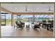 Covered lanai with wicker furniture and views of the landscaped backyard and pool area at 3097 Bureau Path, The Villages, FL 32163