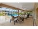 Spacious lanai with outdoor seating overlooking the pool and manicured landscaping at 3097 Bureau Path, The Villages, FL 32163
