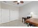 Bright office area with tiled floors, ceiling fan, closet, and desk for convenient workspace at 3097 Bureau Path, The Villages, FL 32163