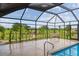 Indoor pool featuring manicured green space, bench seating, and an elegant gazebo, providing the perfect poolside view at 3097 Bureau Path, The Villages, FL 32163