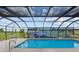 Covered pool area with a scenic mural, and outdoor seating, creating a relaxing and picturesque space at 3097 Bureau Path, The Villages, FL 32163