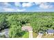 Expansive aerial view of a home surrounded by verdant trees showcasing an idyllic neighborhood setting at 34231 Shadewood Cir, Leesburg, FL 34788
