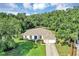 Picturesque aerial view of home featuring pristine lawn, lush trees, and neighborhood at 34231 Shadewood Cir, Leesburg, FL 34788