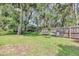 Spacious backyard featuring a well-maintained lawn and a wooden fence, perfect for outdoor activities at 34231 Shadewood Cir, Leesburg, FL 34788